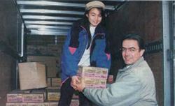 Tim Peters unloads food from a truck for starving North Koreans.